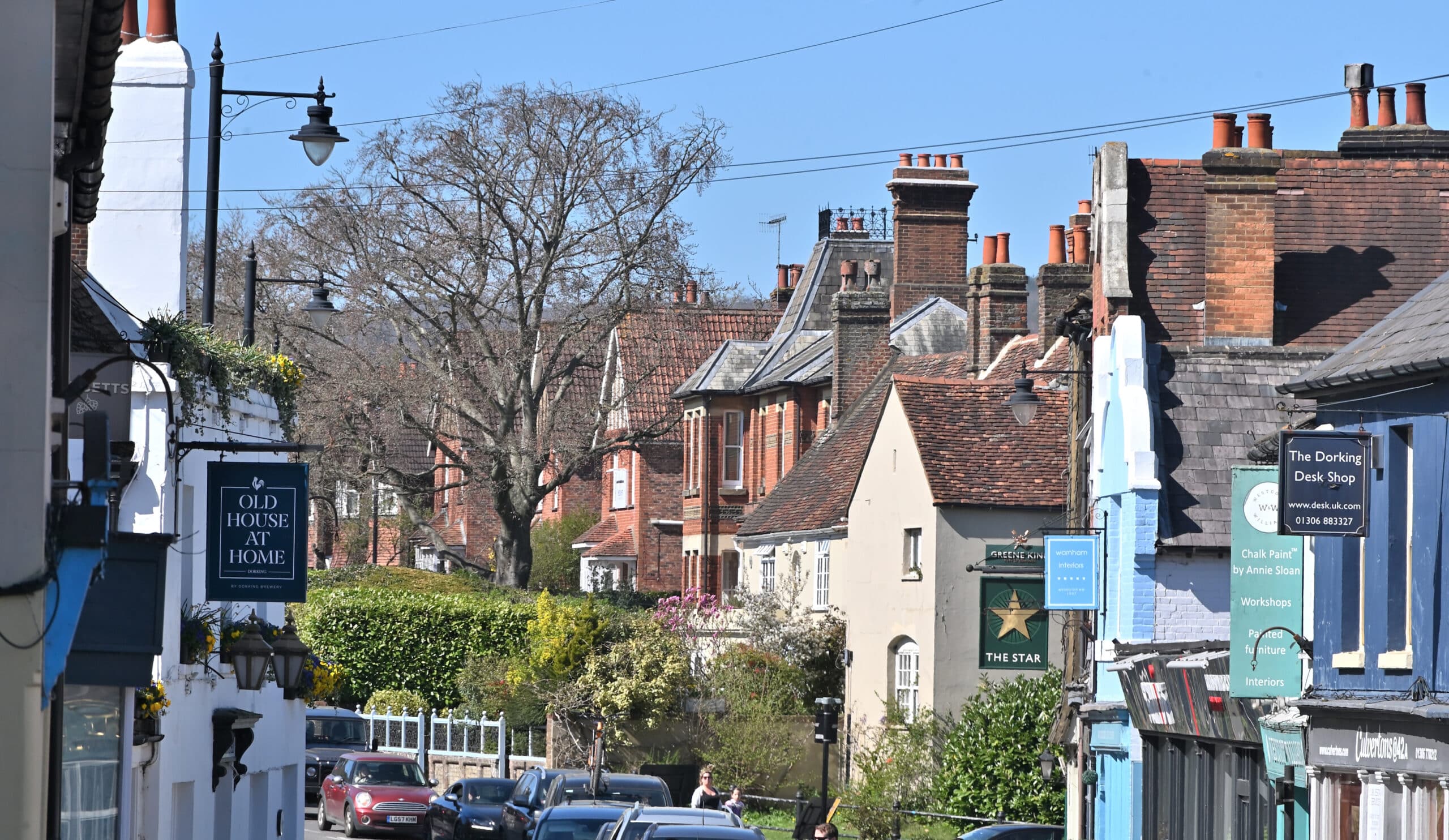 Dorking West Street showing independent businesses including The Star pub and The Old House At Home
