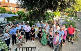 BID members gathering in Downs Solicitors heritage garden for a summer social event in Dorking