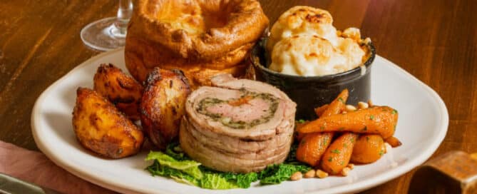 Traditional Sunday roast with Yorkshire puddings and roast potatoes served in a Dorking pub