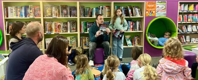 Children and families listening to a storytime session at Dorking Library in Surrey