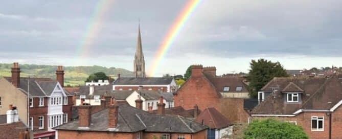 View across Dorking Surrey during May half term with rainbow over the town