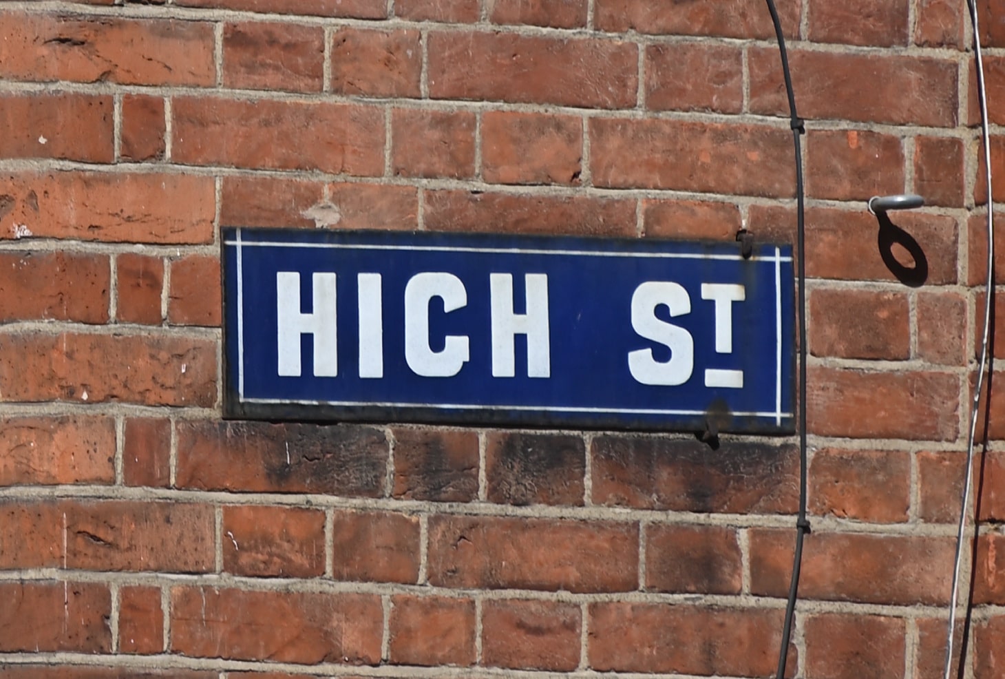 Dorking High Street sign for business funding and support advice in Surrey