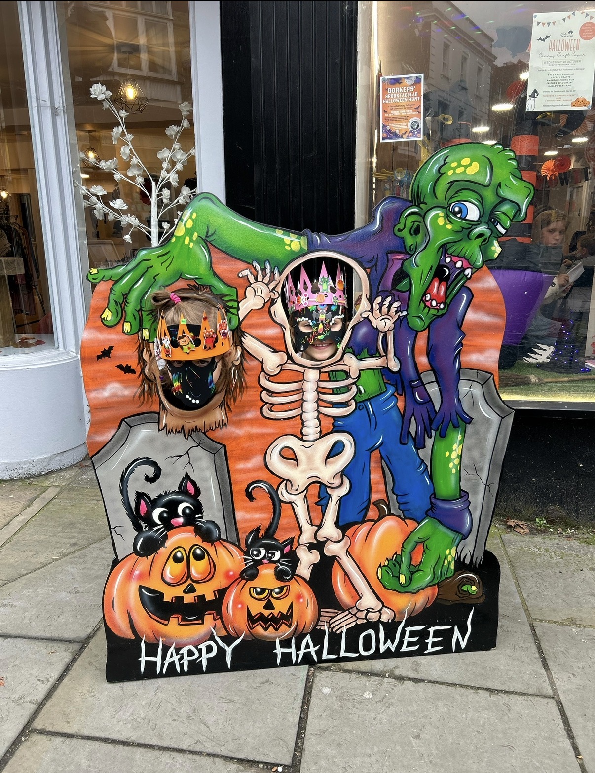 Children enjoying a Halloween photo display in Dorking, Surrey